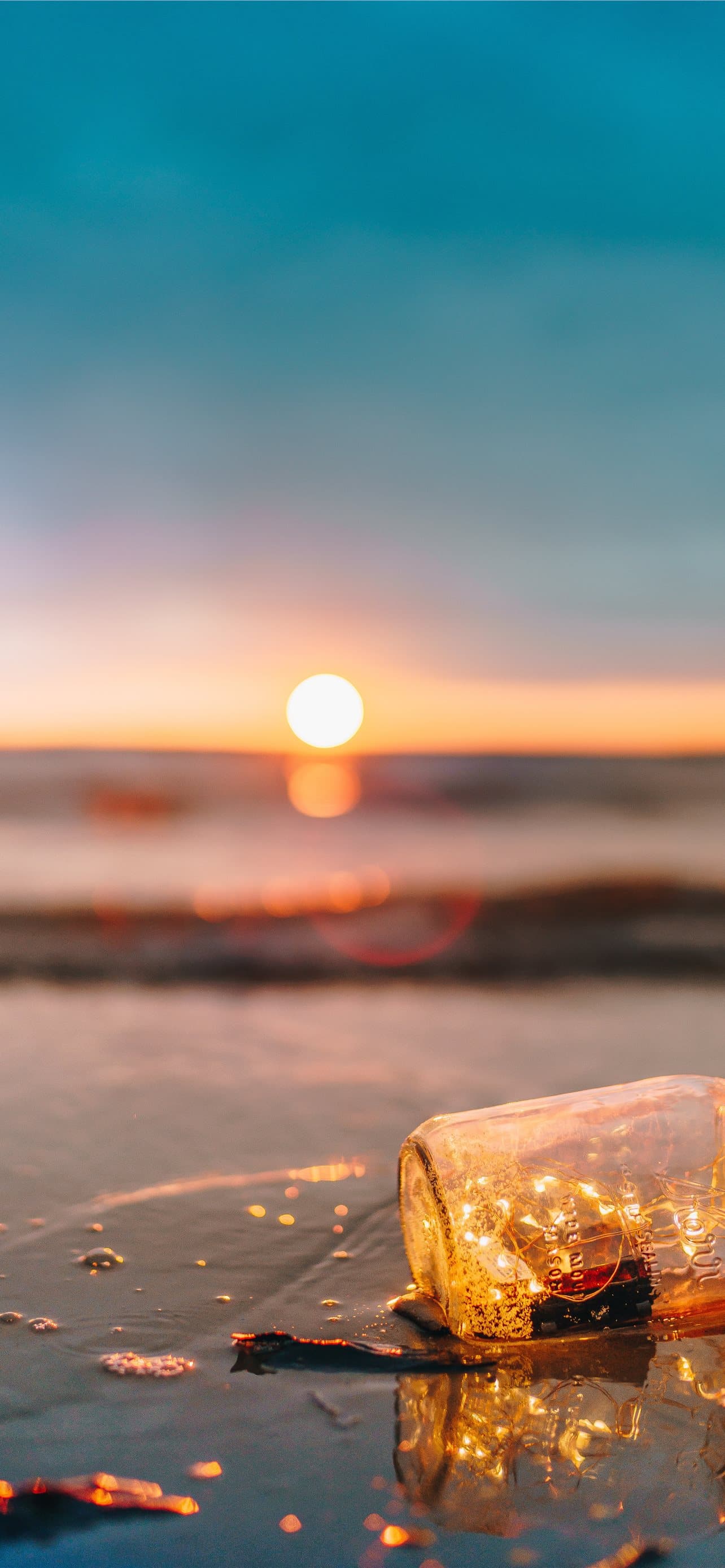 Clear Glass Mason Jar On Beach During Sunset
