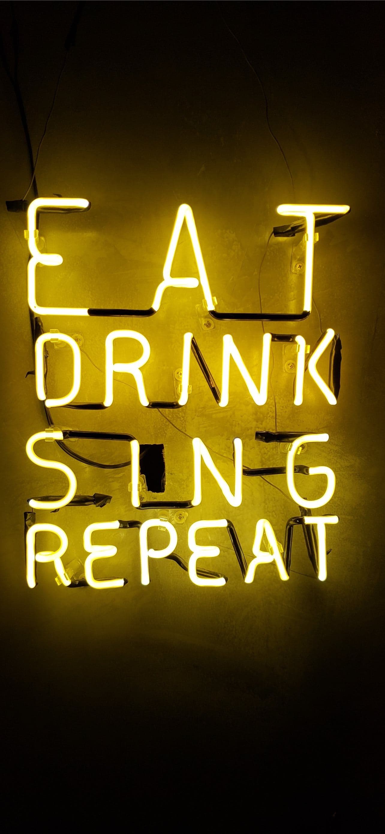 Turned On Eat Drink Sing Repeat Neon Signage On Wa